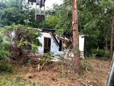 Ongoing Residential Demolition using a dozer to knock down the structure