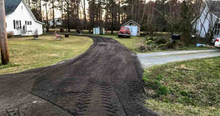 Grading the driveway surface in preparation for road construction