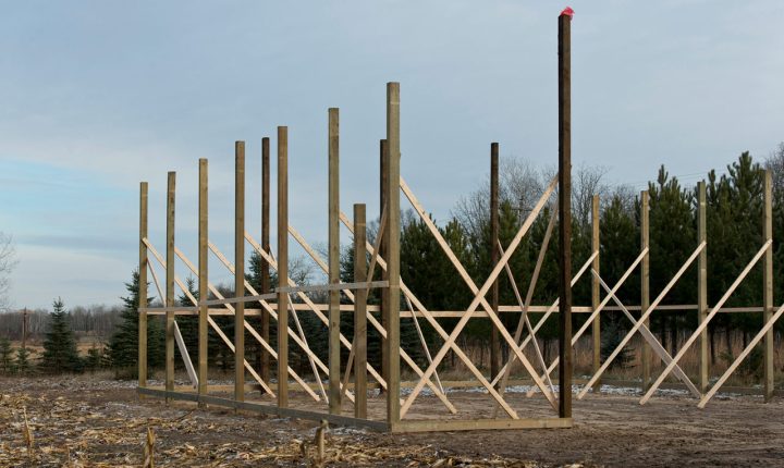 An emerging pole barn on expansive grounds with frames still being completed